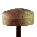Side view of oval crown with flat top.